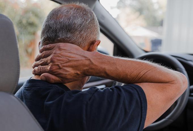 Man holding neck in pain after whiplash injury