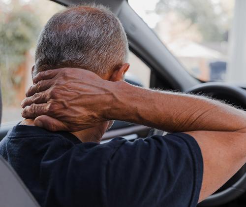 Man holding neck in pain after whiplash injury